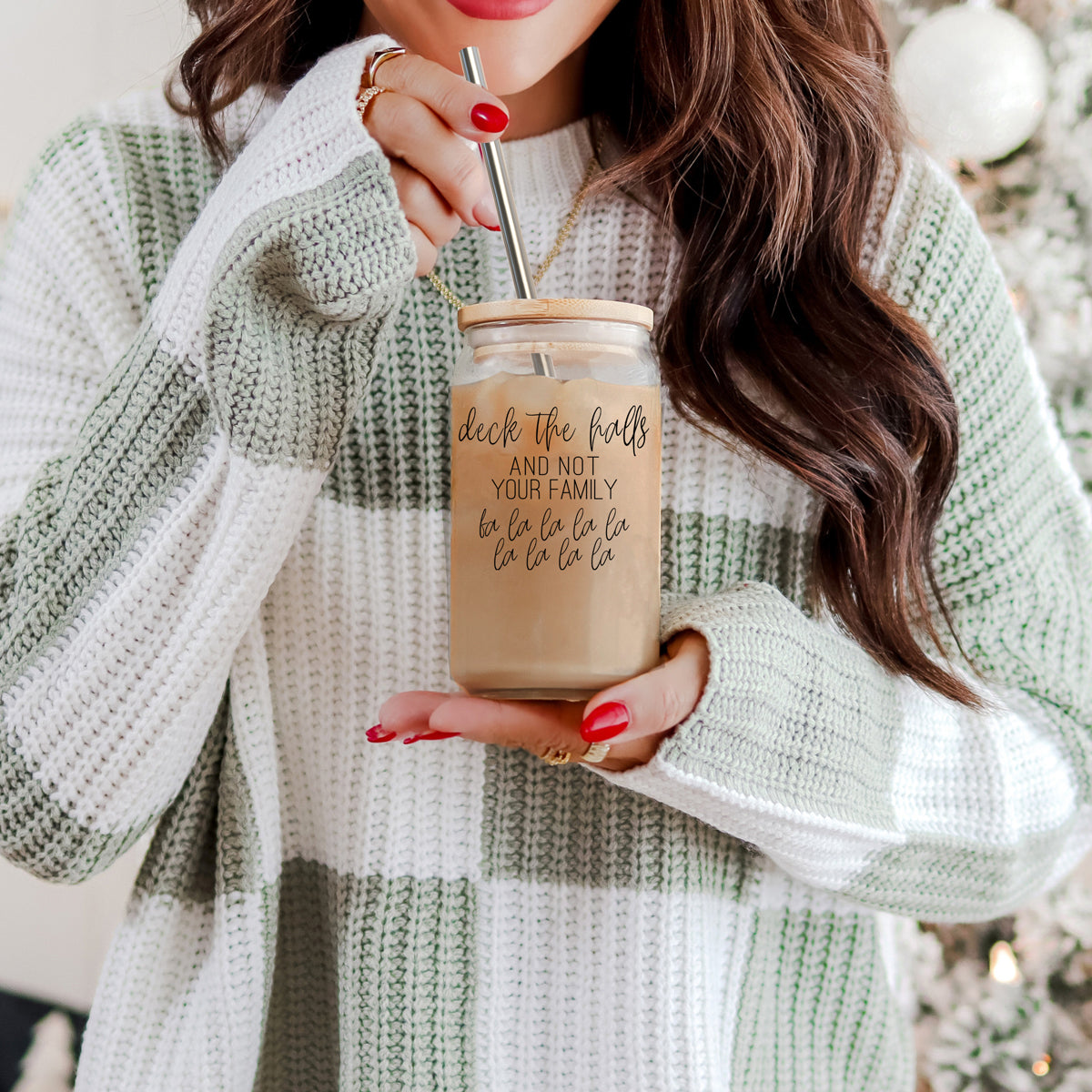 Deck the Halls 17oz Gia Roma glass tumbler with bamboo lid held in a white-green knit sweater on Tampa Home & Garden Store