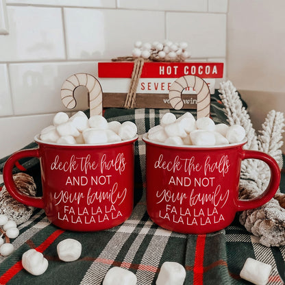 Pair of Gia Roma red Deck The Halls mugs with white script lettering, stuffed with marshmallows on Tampa Home & Garden Store