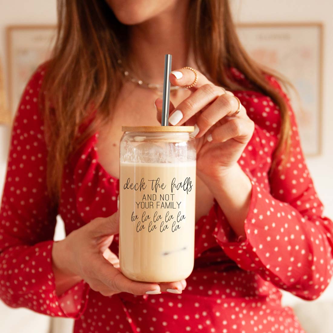 Deck the Halls 17oz glass cup by Gia Roma with lid and straw, beige beverage in hand on Tampa Home & Garden Store