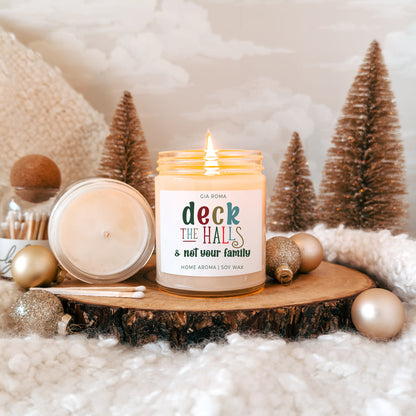 Deck The Halls candle by Gia Roma in cream soy wax jar on wood slice with festive decor on Tampa Home & Garden Store