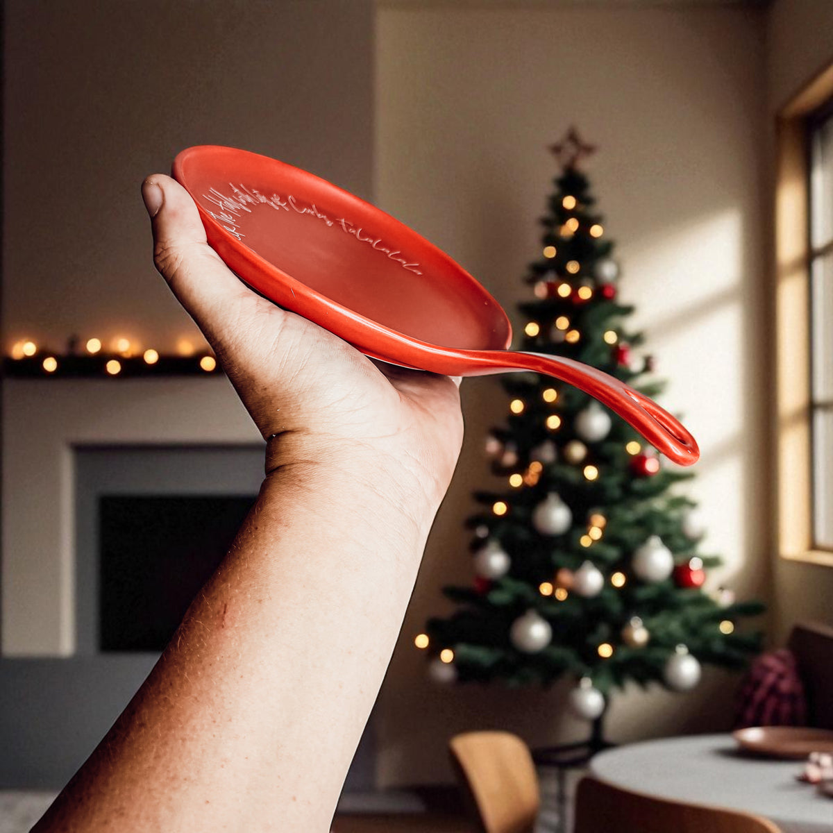 Deck the Halls & Carbs spoon rest by Gia Roma, red accessory with Christmas tree backdrop on Tampa Home & Garden Store