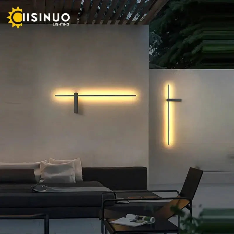 Modern minimalist black aluminum wall sconce pair with warm LED glow on white porch wall on Tampa Home & Garden Store