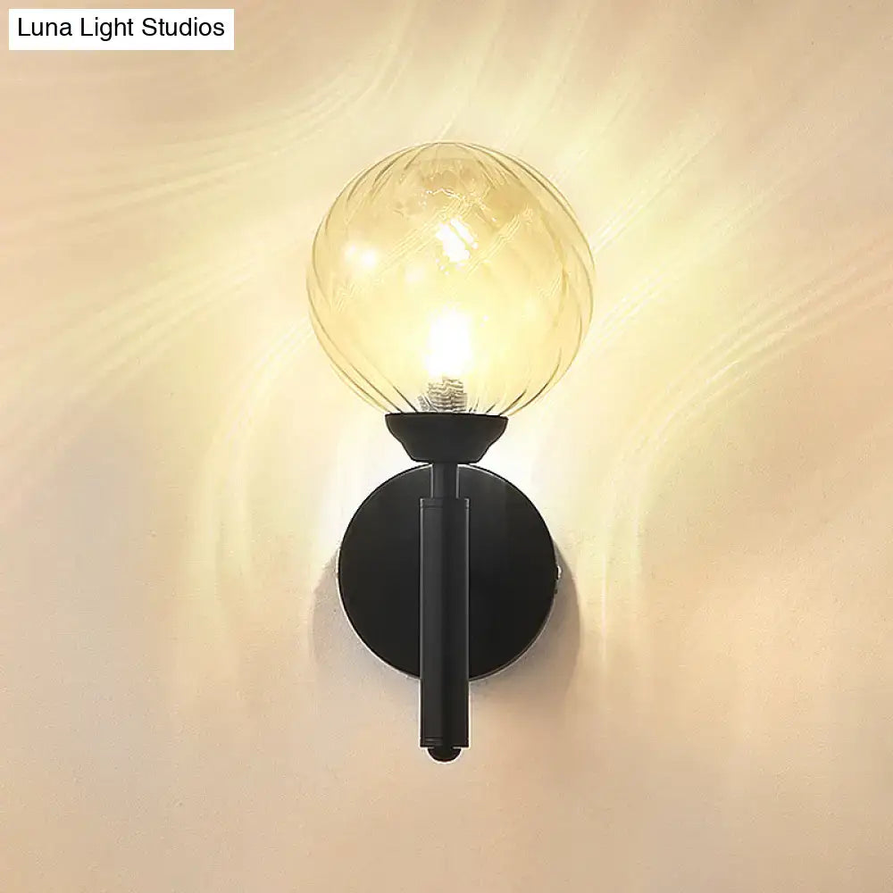 Black textured glass wall sconce with round backplate and glass globe bulb by Decorbites on Tampa Home & Garden Store