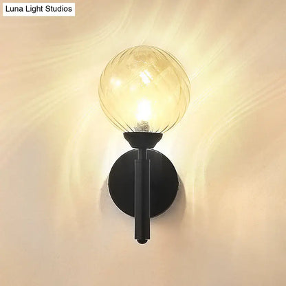 Black textured glass wall sconce with round backplate and glass globe bulb by Decorbites on Tampa Home & Garden Store