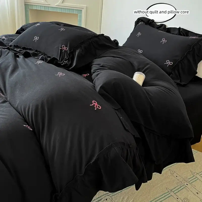 Duvet cover set by Decorbites in black with pink bow embroidery and ruffles on bed on Tampa Home & Garden Store