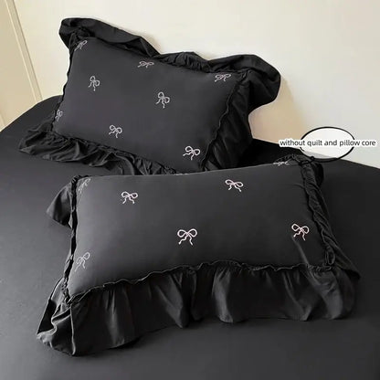 Black bow-embroidered pillowcase pair by Decorbites with ruffled edges on Tampa Home & Garden Store