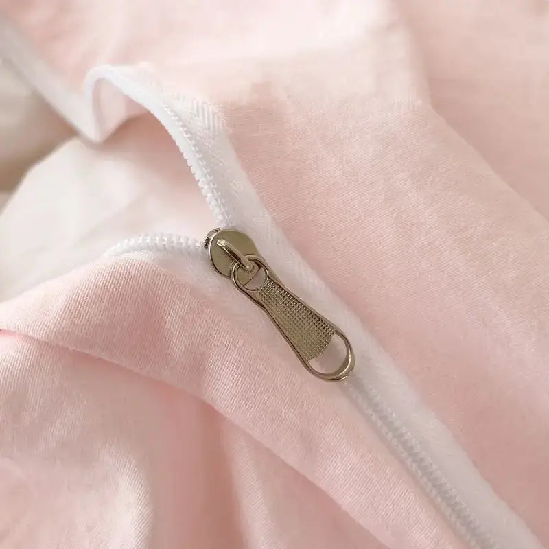 Duvet cover close-up on soft pink fabric with a silver zipper and white trim on Tampa Home & Garden Store