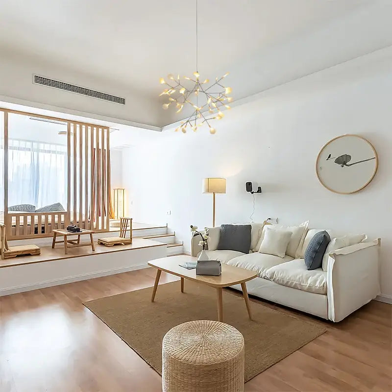 Rose Gold Branch Chandelier by Decorbites over a white sofa in a bright living room on Tampa Home & Garden Store