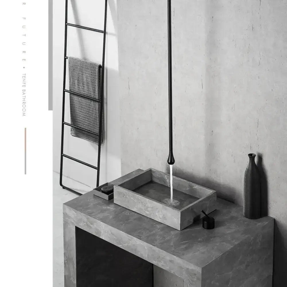 Modern black single-handle bathroom faucet over a rectangular concrete sink on a vanity on Tampa Home & Garden Store