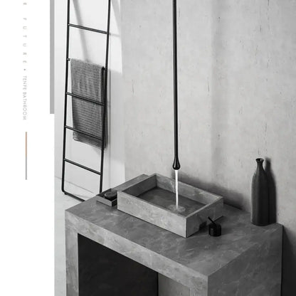 Modern black single-handle bathroom faucet over a rectangular concrete sink on a vanity on Tampa Home & Garden Store