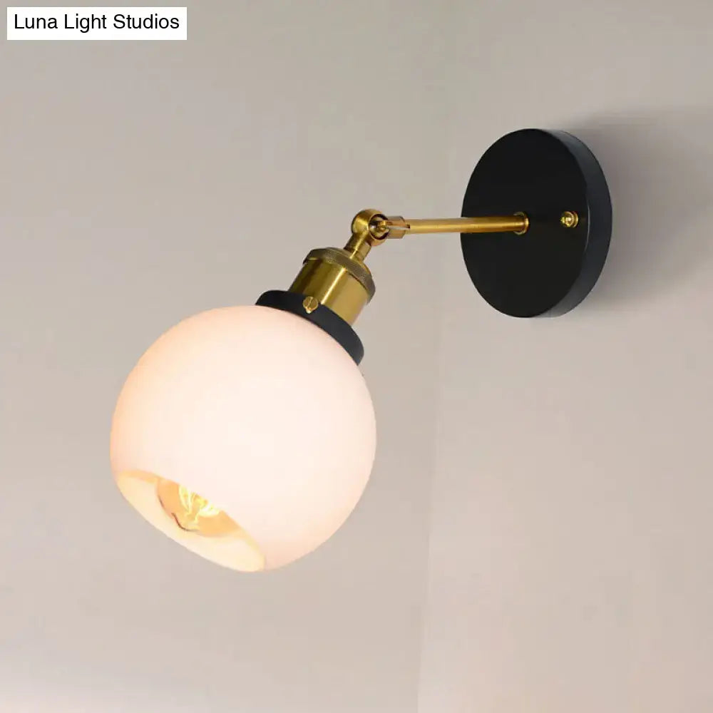 Brass Bubble Glass Sconce with white globe shade on black round wall mount on Tampa Home & Garden Store