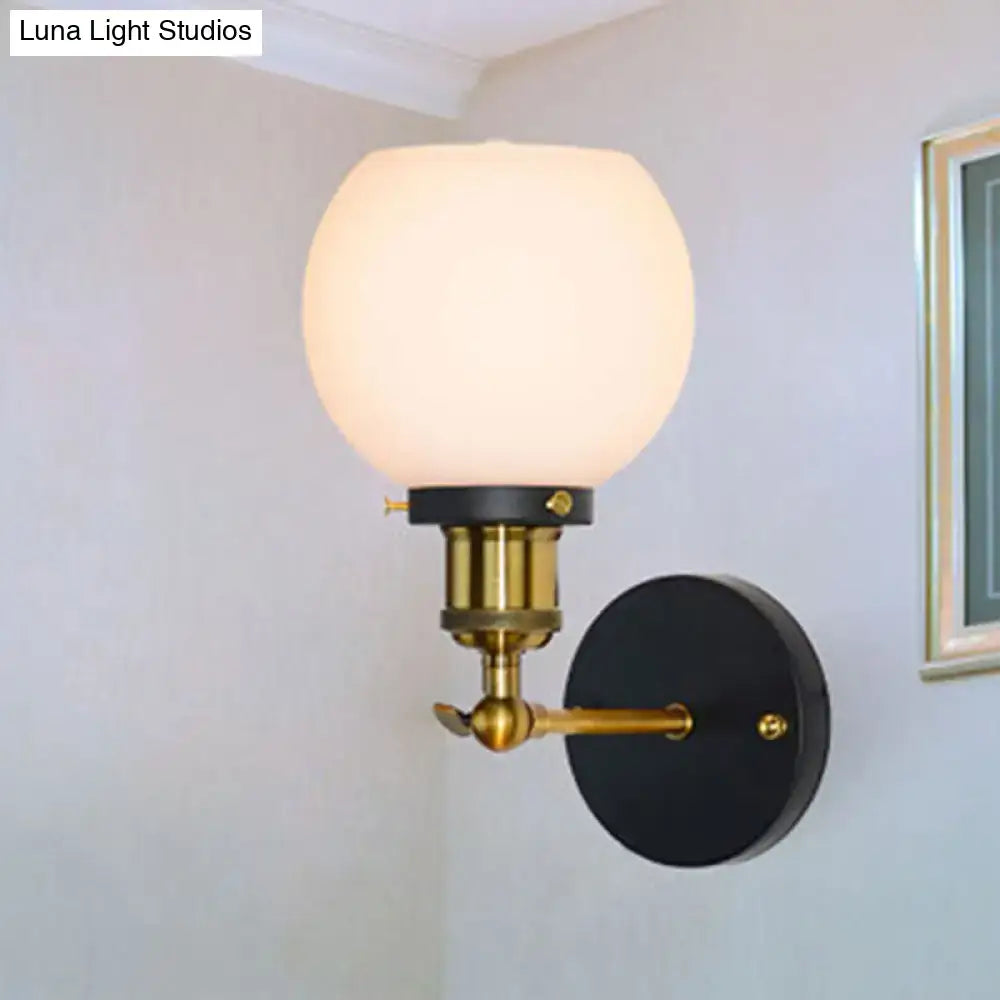 Decorbites brass bubble glass wall sconce with frosted globe and black backplate on Tampa Home & Garden Store