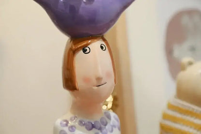 Blue ceramic vase set by Decorbites; whimsical white figurine with purple bird on head on Tampa Home & Garden Store