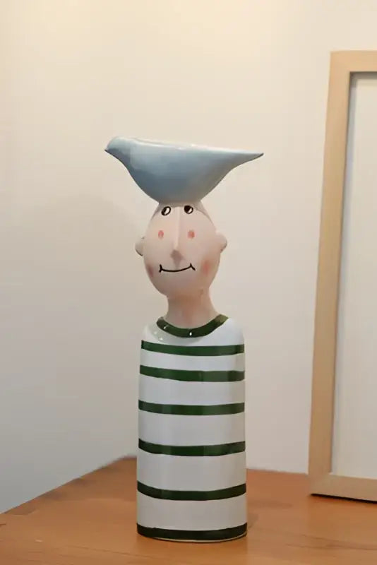 Blue ceramic vase set: striped white and green vase with a blue bird perched on its head on Tampa Home & Garden Store
