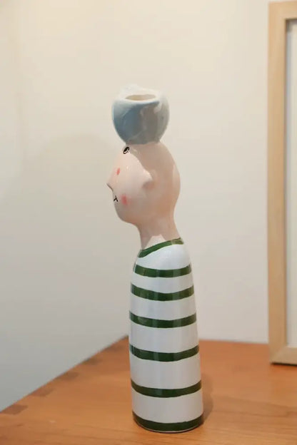 Blue ceramic vase by Decorbites with tall white body, green stripes, pink head, blue bowl on top on Tampa Home & Garden Store