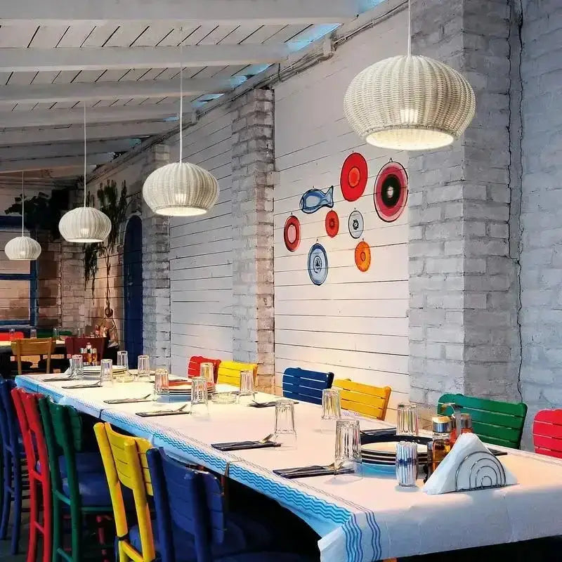 Chinese style outdoor rattan pendant lights Decorbites over a dining table with colorful chairs on Tampa Home & Garden Store