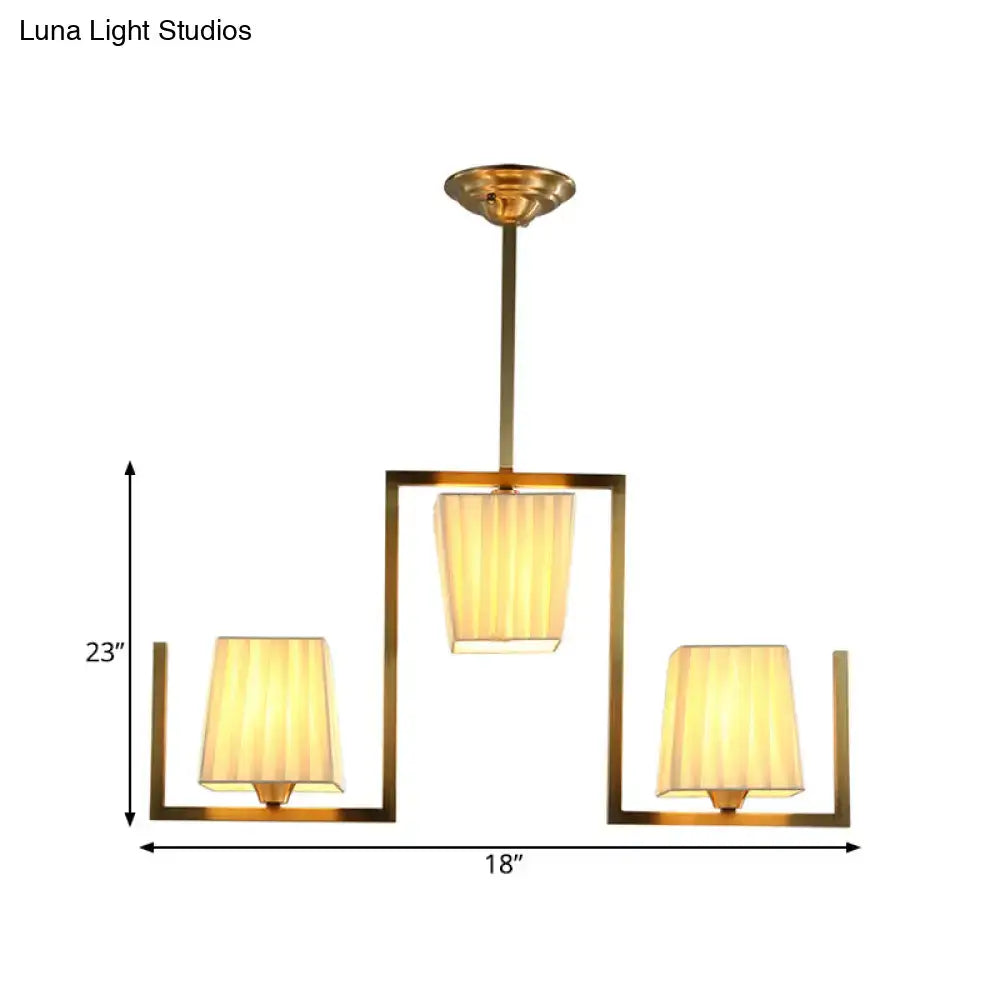 Brass modern ceiling light fixture with three fabric shades in an open square frame Decorbites on Tampa Home & Garden Store