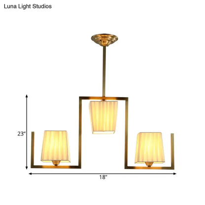 Brass modern ceiling light fixture with three fabric shades in an open square frame Decorbites on Tampa Home & Garden Store