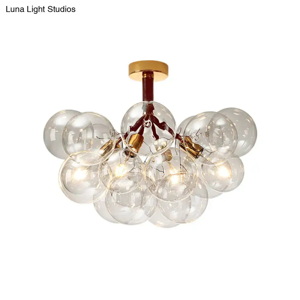 Brass bubble light chandelier with clear glass globes clustered around a gold canopy on Tampa Home & Garden Store