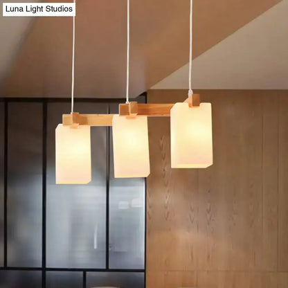 Wood and white glass cluster pendant kitchen light with three shades on wood bar Decorbites on Tampa Home & Garden Store