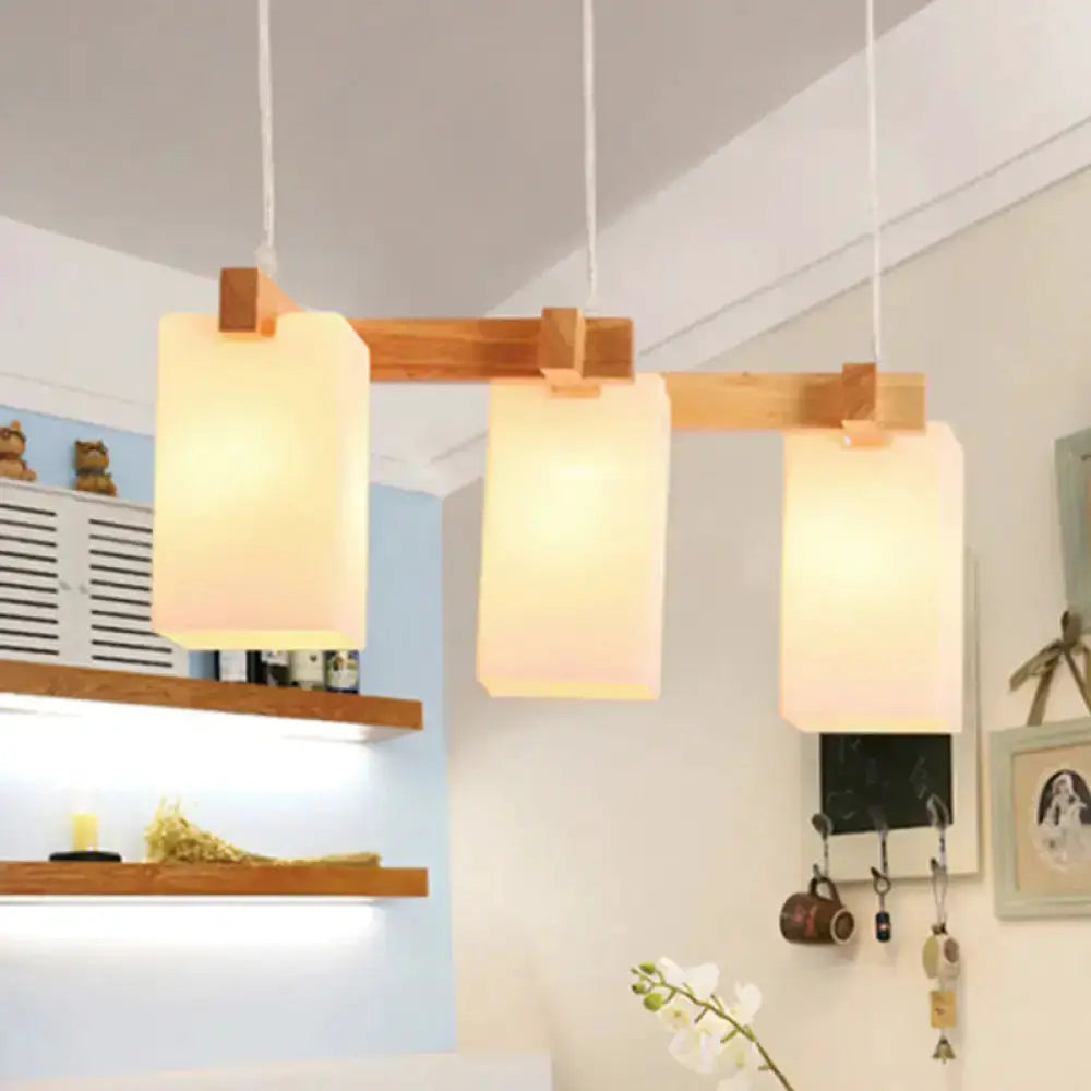 Wood and white glass cluster pendant light, 3 frosted shades on a wooden bar on Tampa Home & Garden Store