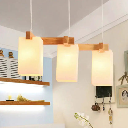 Wood and white glass cluster pendant light, 3 frosted shades on a wooden bar on Tampa Home & Garden Store