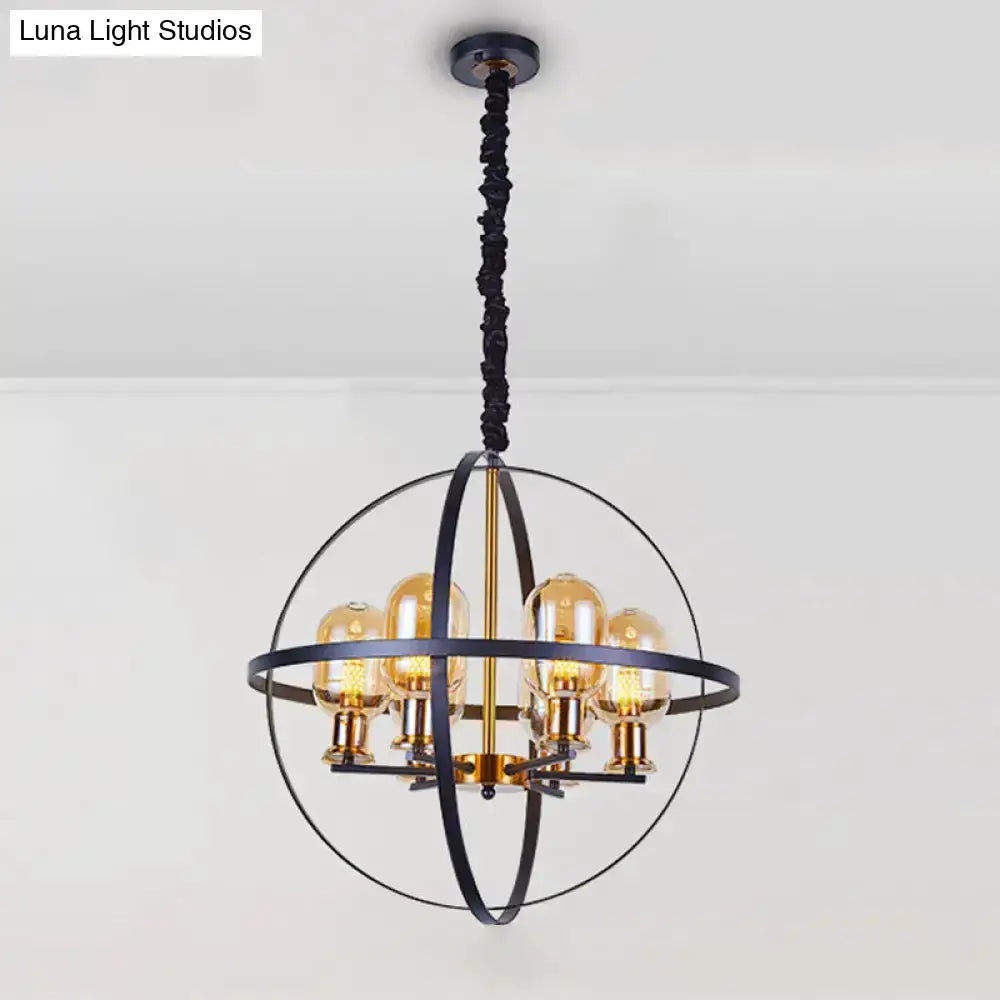 Industrial amber glass pendant chandelier with brass accents inside a black spherical frame on Tampa Home & Garden Store