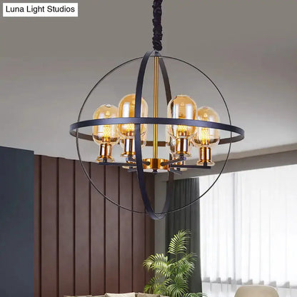 Industrial amber glass pendant chandelier with brass finish and circular orb frame on Tampa Home & Garden Store