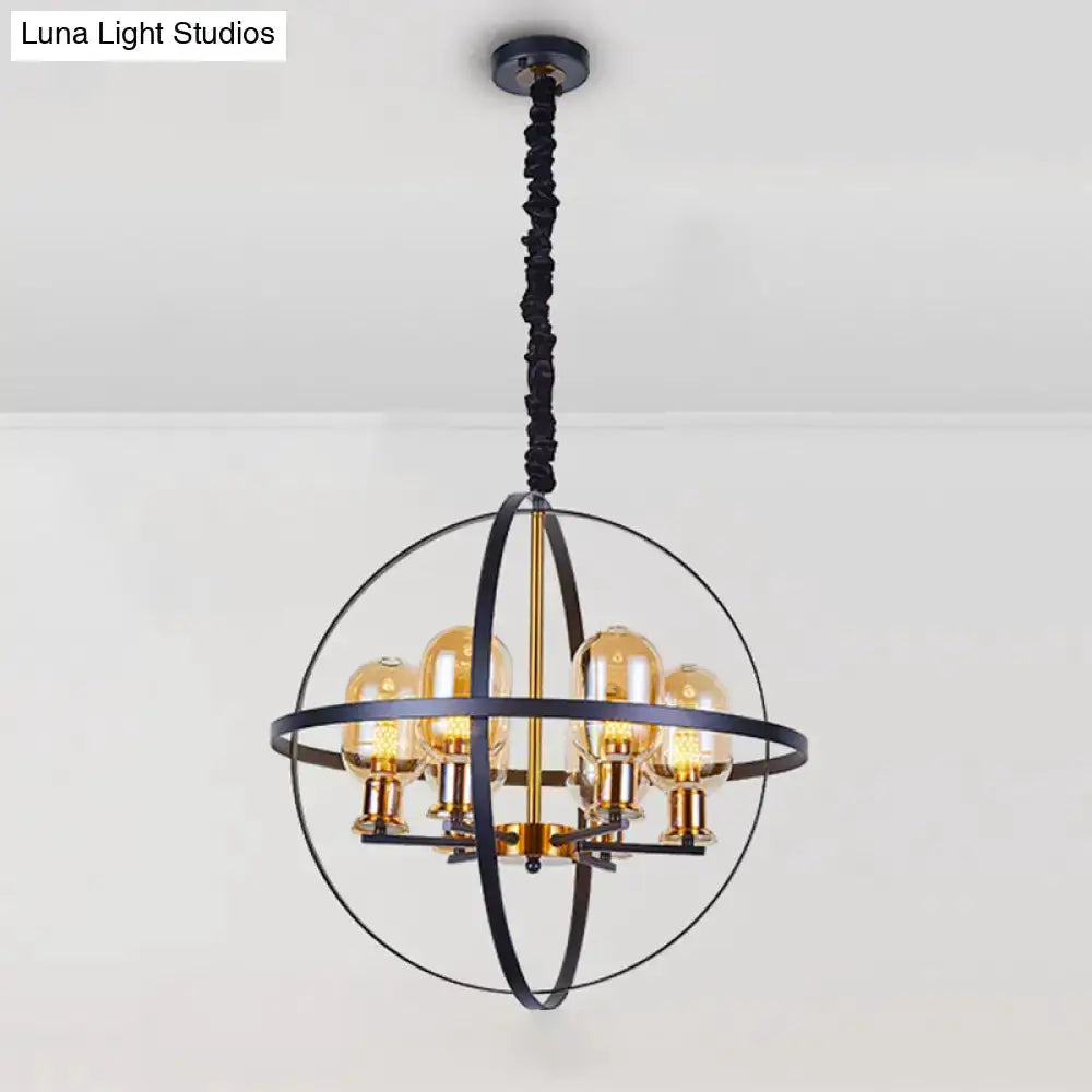 Industrial amber glass pendant chandelier with black metal globe frame and brass accents on Tampa Home & Garden Store