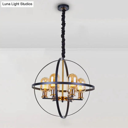 Industrial amber glass pendant chandelier with black metal globe frame and brass accents on Tampa Home & Garden Store