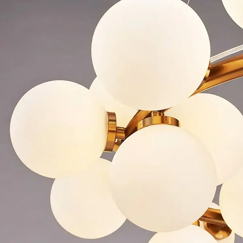 Black Gold Glass Ball Chandelier by Decorbites with frosted white globes and gold hardware on Tampa Home & Garden Store
