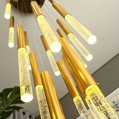 Modern gold crystal chandelier with cylindrical glass tubes and warm LED glow on Tampa Home & Garden Store