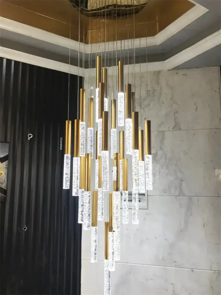 Modern gold crystal chandelier by Decorbites with cascading gold tubes and crystal prisms on Tampa Home & Garden Store