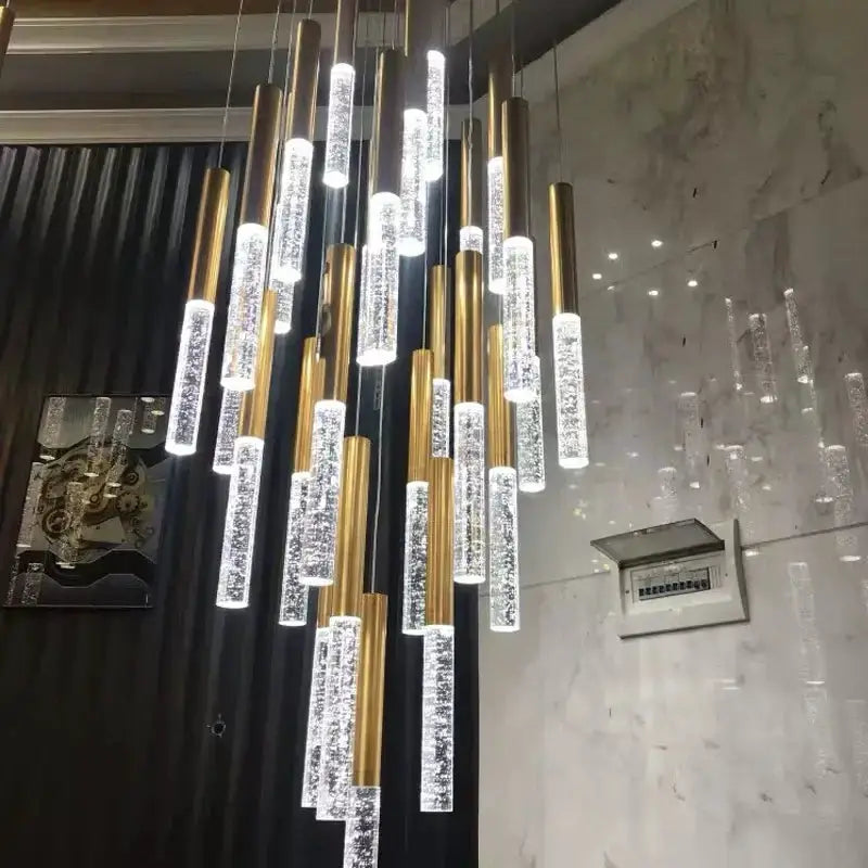 Modern gold crystal chandelier with clustered cylindrical pendant lights and clear crystal accents on Tampa Home & Garden Store