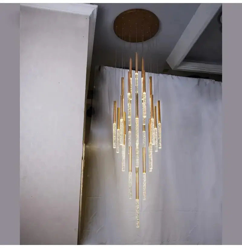 Modern gold crystal chandelier with cascading glass rods by Decorbites on Tampa Home & Garden Store