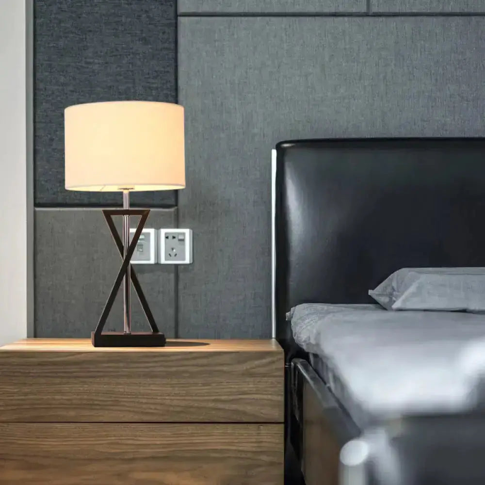 Decorbites modern hourglass table lamp with white fabric shade on wooden nightstand beside bed on Tampa Home & Garden Store