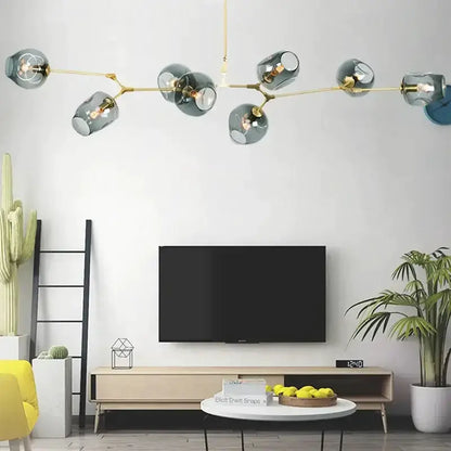 Chandelier: modern teal glass bubble eight-globe light with gold arms over living room TV on Tampa Home & Garden Store