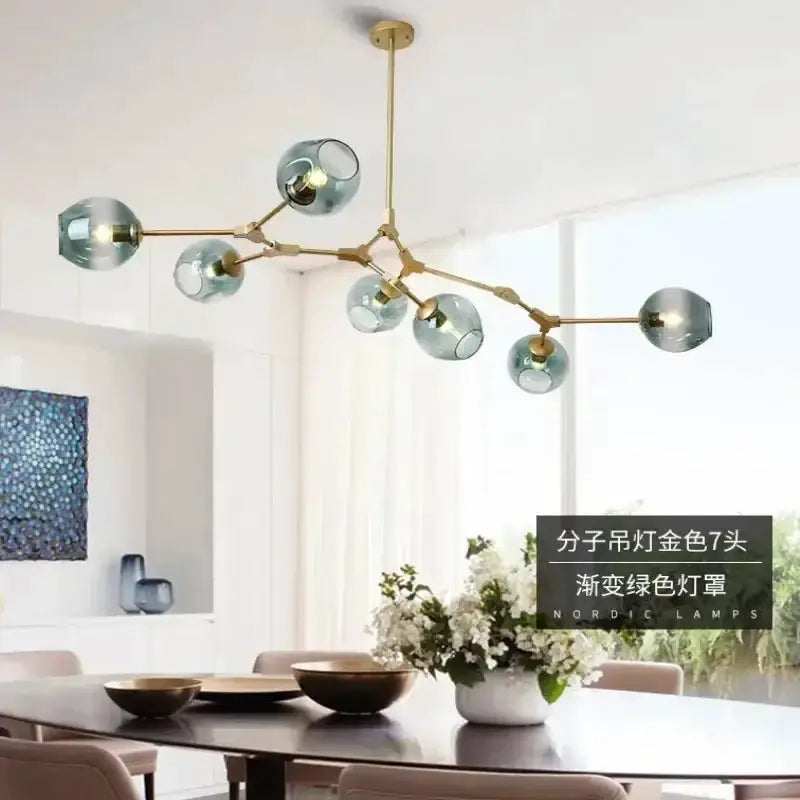 Modern teal glass bubble chandelier by Decorbites with brass arms and eight globes on Tampa Home & Garden Store
