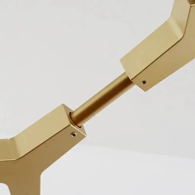 Chandelier arm close-up in gold brass with jointed segments Decorbites on Tampa Home & Garden Store