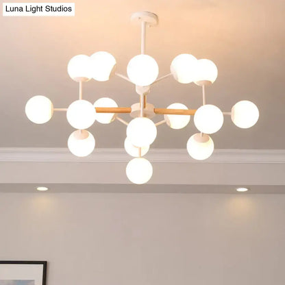 White Globe Chandelier by Decorbites with white glass globes and wood-toned arms on Tampa Home & Garden Store