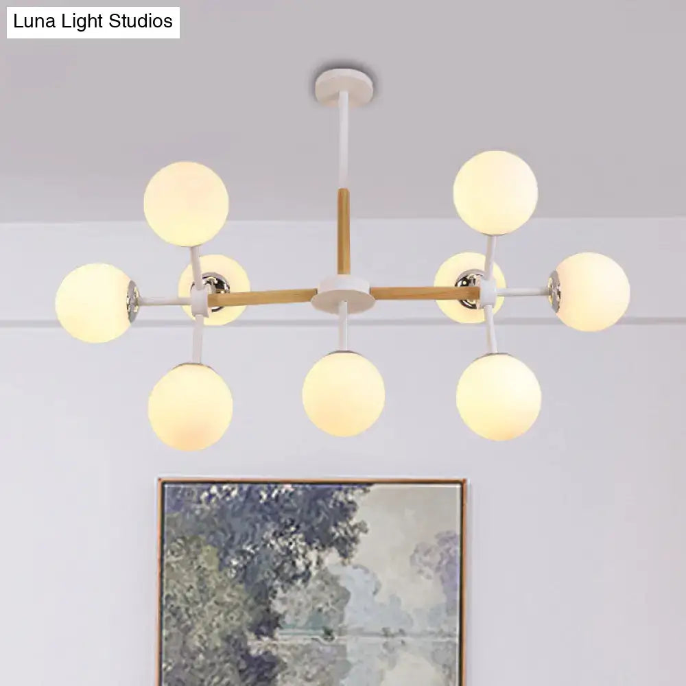White globe chandelier with wood crossbars and eight spherical bulbs by Decorbites on Tampa Home & Garden Store