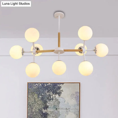 White globe chandelier with wood crossbars and eight spherical bulbs by Decorbites on Tampa Home & Garden Store
