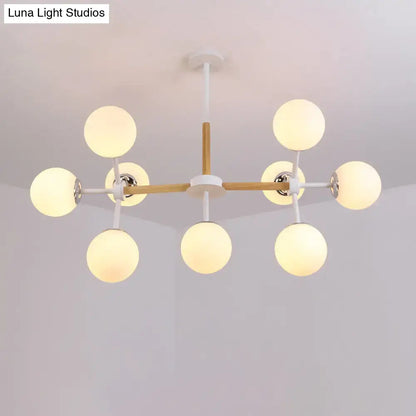 White Globe Chandelier with eight globes on wood and white metal arms by Decorbites on Tampa Home & Garden Store