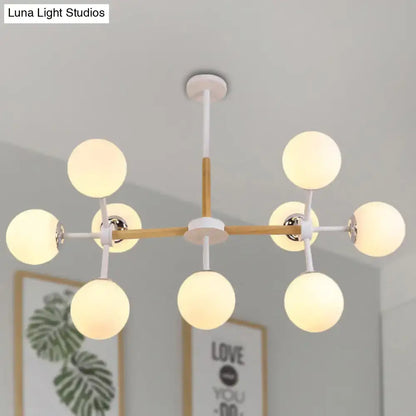 White Globe Chandelier by Decorbites with wooden arms and globe bulbs, sputnik style on Tampa Home & Garden Store