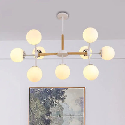 White Globe Chandelier by Decorbites with wood-accent frame and warm frosted globe bulbs on Tampa Home & Garden Store