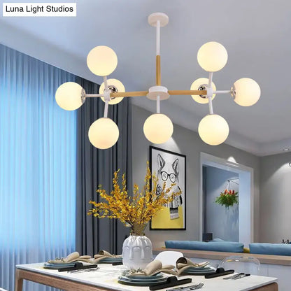 White Globe Chandelier by Decorbites with wood-accent arms and white globe bulbs on Tampa Home & Garden Store