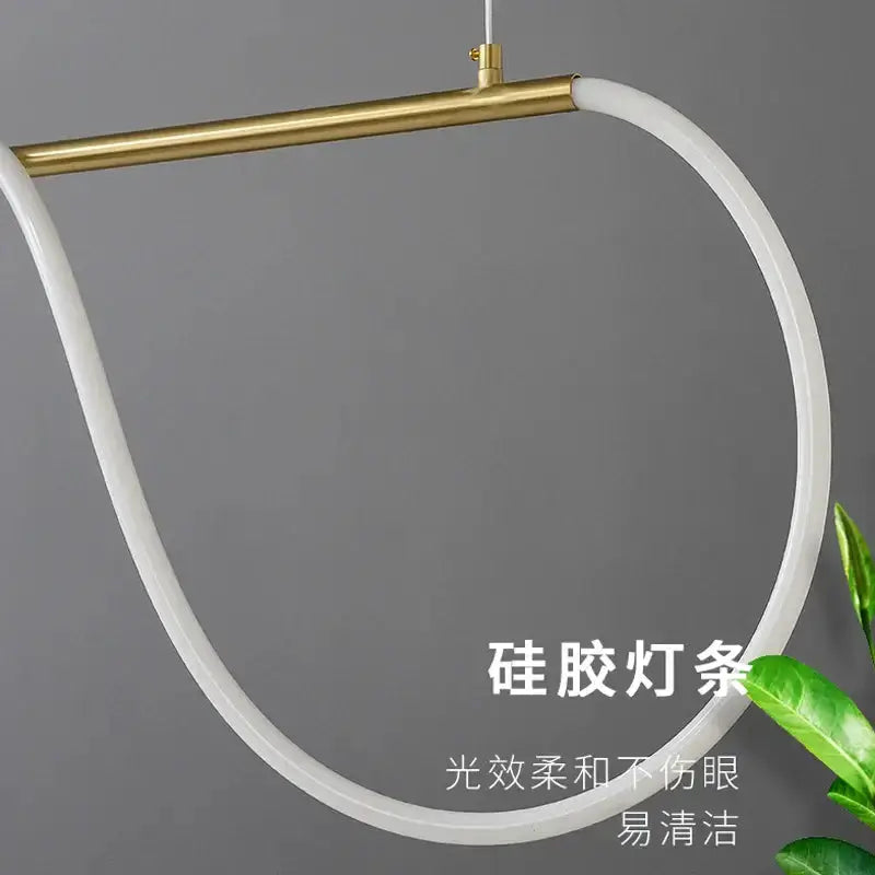 Decorbites modern gold curved LED chandelier pendant with circular white ring and brass bar on Tampa Home & Garden Store