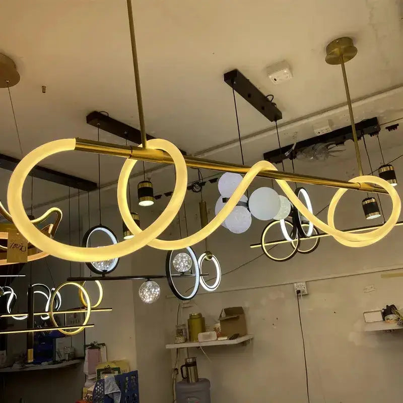 Modern gold curved contemporary LED chandelier with looping rings, ceiling pendant lighting on Tampa Home & Garden Store