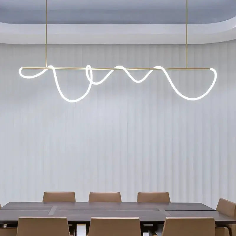 Modern gold curved LED pendant chandelier with wavy light over dining table on Tampa Home & Garden Store