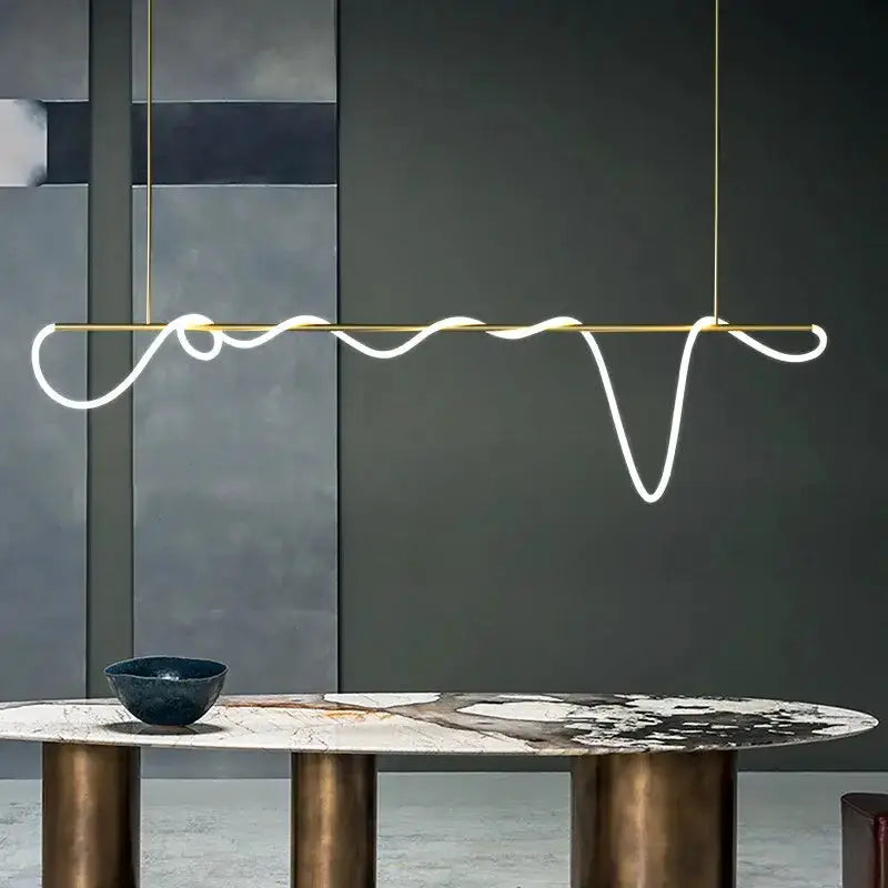 Modern gold curved LED chandelier pendant by Decorbites with a wavy white glow on Tampa Home & Garden Store